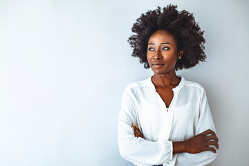 Portrait of attractive young black woman smiling against isolated white background. Close up portrait of an attractive young african american woman looking at camera