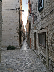 Fototapeta na wymiar Tourist city by the Adratic sea - Sibenik, Croatia. The old stones, narrow street and stairs