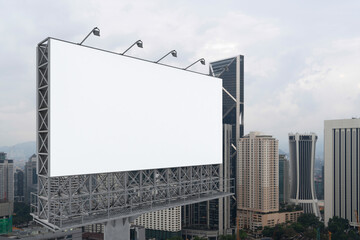 Blank white road billboard with KL cityscape background at day time. Street advertising poster, mock up, 3D rendering. Side view. The concept of marketing communication to promote or sell idea.