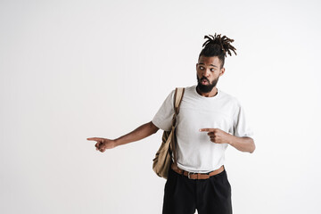 Photo of surprised african american guy pointing fingers aside