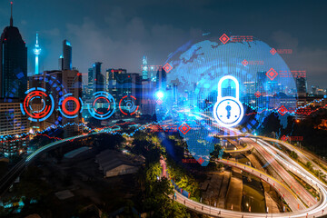 Glowing Padlock hologram, night panoramic city view of Kuala Lumpur, Malaysia, Asia. The concept of...
