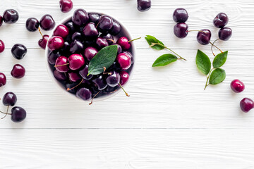Sweet red cherries with leaves, flat lay, top view