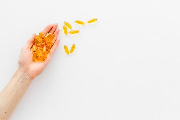 Omega fish cod liver oil capsules in hands, copy space
