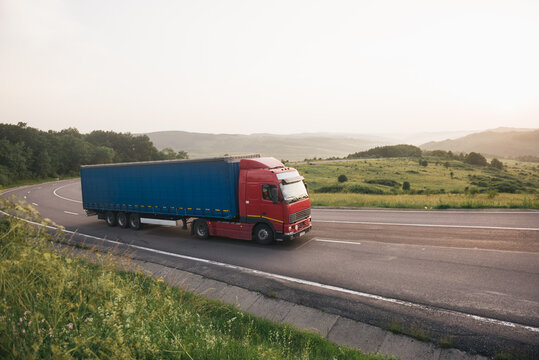 Blue and red truck on the road