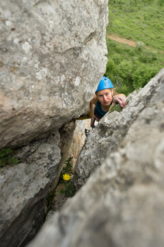 Young woman trad climbing