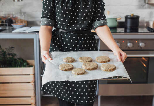 Woman Holding Baking Tray With Bannocks