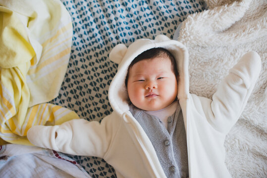Smiling baby lying on bed