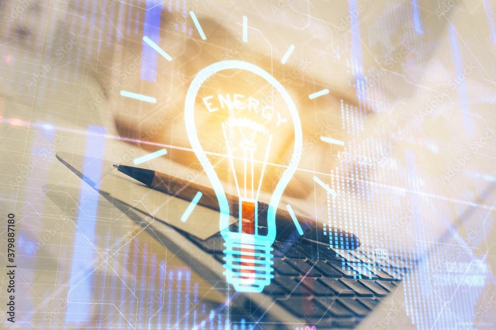 Poster Computer on desktop in office with bulb icon hologram. Double exposure. Concept of idea.
