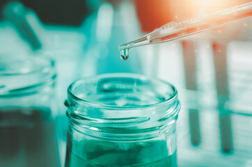 Pipette dropping a sample into a test tube and science experiments ,Laboratory glassware containing chemical liquid,