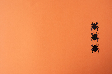 Top view of scary spiders on orange background with copy space