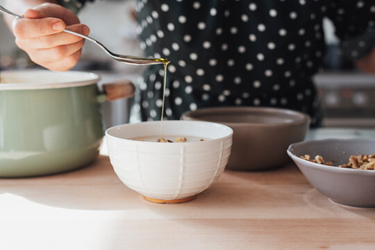 A Cook Pouring Olive Oil in Bisque