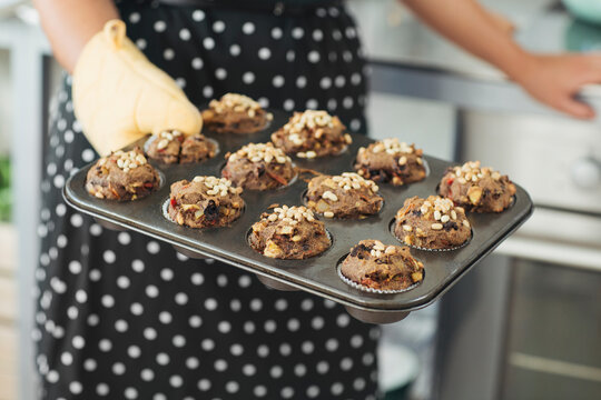Woman Holding Mould With baked Muffins