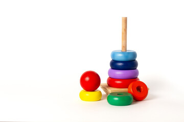 toy pyramid, wooden, multi - colored rings, on a white background 