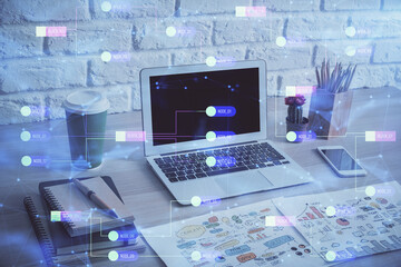 Double exposure of desktop computer and technology theme hologram. Concept of software development.