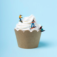 Creative layout made with snowboarders on muffin. Minimal colorful winter sports concept.