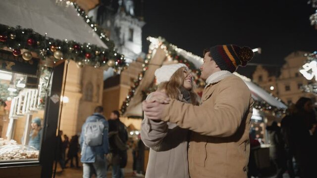 Happy couple dancing in xmas Prague. Love, family, christmas, new year, holiday concept. Filmed on RED camera, 10 bit clolor
