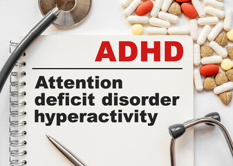 Page in notebook with ADHD Attention deficit hyperactivity disorder on white background with...