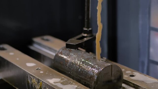 Slow motion: wire cutting machine working with metal workpiece with sparks at factory, exhibition, plant. Metalworking, industrial, machining, technology, manufacturing, equipment concept