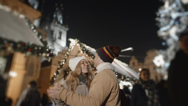 Happy couple dancing at xmas square in Prague. Love, family, christmas, new year, holiday concept. Filmed on RED camera, 10 bit clolor