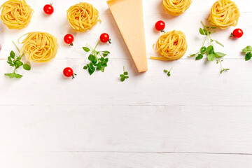 Ingredients for cooking pasta - tagliatelle, tomato, garlic, basil, parmesan cheese