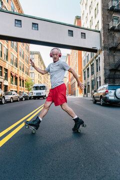 Active Senior Lifestyle Shot of Man Roller Skating in City Environment