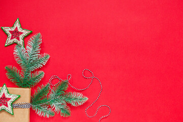 Christmas background with fir tree branches and red color decor