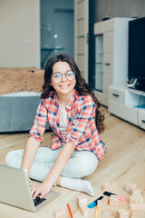 Beautiful happy girl typing and smiling cheerfully