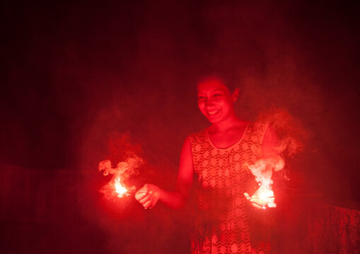 Indian woman making fun with firecrackers