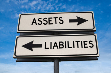 Assets and liabilities white road sign with arrow on blue sky background. Directional road. Crossroads Road Sign, Two Arrow. Blue sky background. Two way road sign with text.
