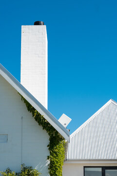 Detail of pitched roof and chimney of modern farmhouse design