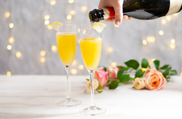 Mimosa festive drink for Christmas - Champagne cocktail Mimosa with orange juice for party