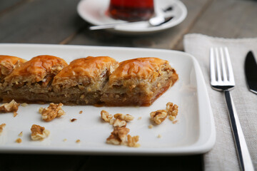 Baklava with walnut on a white plate horizontal view