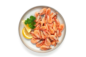 Boiled shrimp prawns in a shell with lemon and parsley in a plate on a white background. Top view