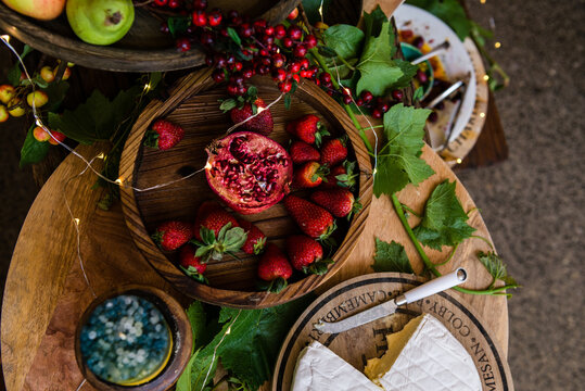 overhead of cheeses and fruits on a gourmet food buffet at a par