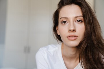 Fototapeta premium Close-up portrait of an attractive young woman smiling