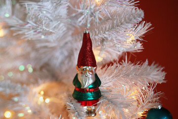 A Festive Gnome Ornament On A White Vintage Tree
