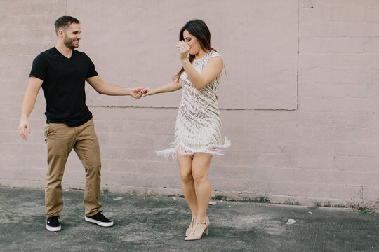 Loving young couple dancing outdoors