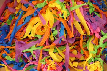 Large mass of brightly colored coloured paper streamers. Backgound of colours clours shapes line...