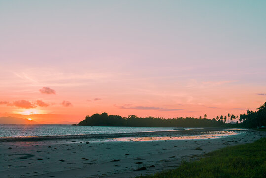sunrise on a stretch of beach in a tropical destination