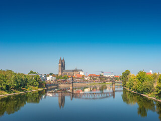 Fototapeta premium Panoramic view over downtown of Magdeburg, old town, Elbe river, bridges and Magnificent Cathedral at early Autumn, Germany, at sunny day and clear blue sky...