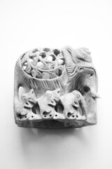 Statuette of a deity made of natural stone on a white background.Elephant and baby elephants