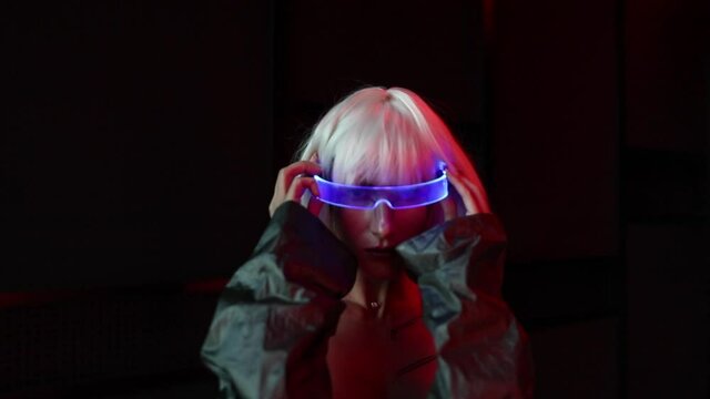 The blonde wears neon glasses