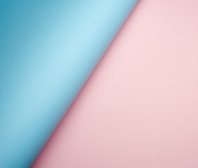 curled blue sheet of paper on pink background, abstract background