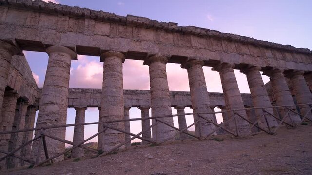 Panning on the greek temple of Segesta at sunset in Sicily, Italy.