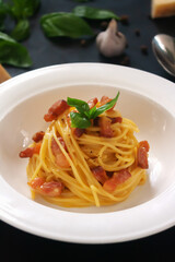 Carbonara paste on a dark background. Vertical orientation