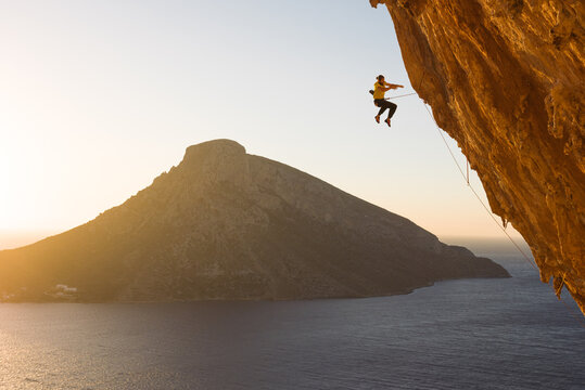 Male rock climber taking a fall from the rock wall