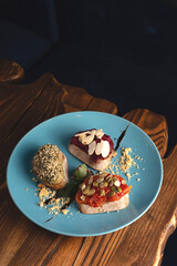Beautifully served vegetarian bruschetta made from beetroot, tomato, hummus with ocher and seeds....