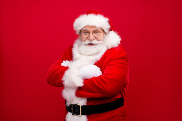 Portrait of his he nice handsome attractive cheerful cheery content overweight glad bearded Santa father wearing festal warm coat folded arms isolated bright vivid shine vibrant red color background