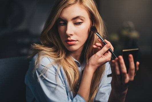 Woman Applying Make Up on Her Face