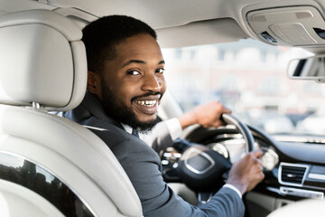 Happy African American Businessman Driving Smiling To Camera